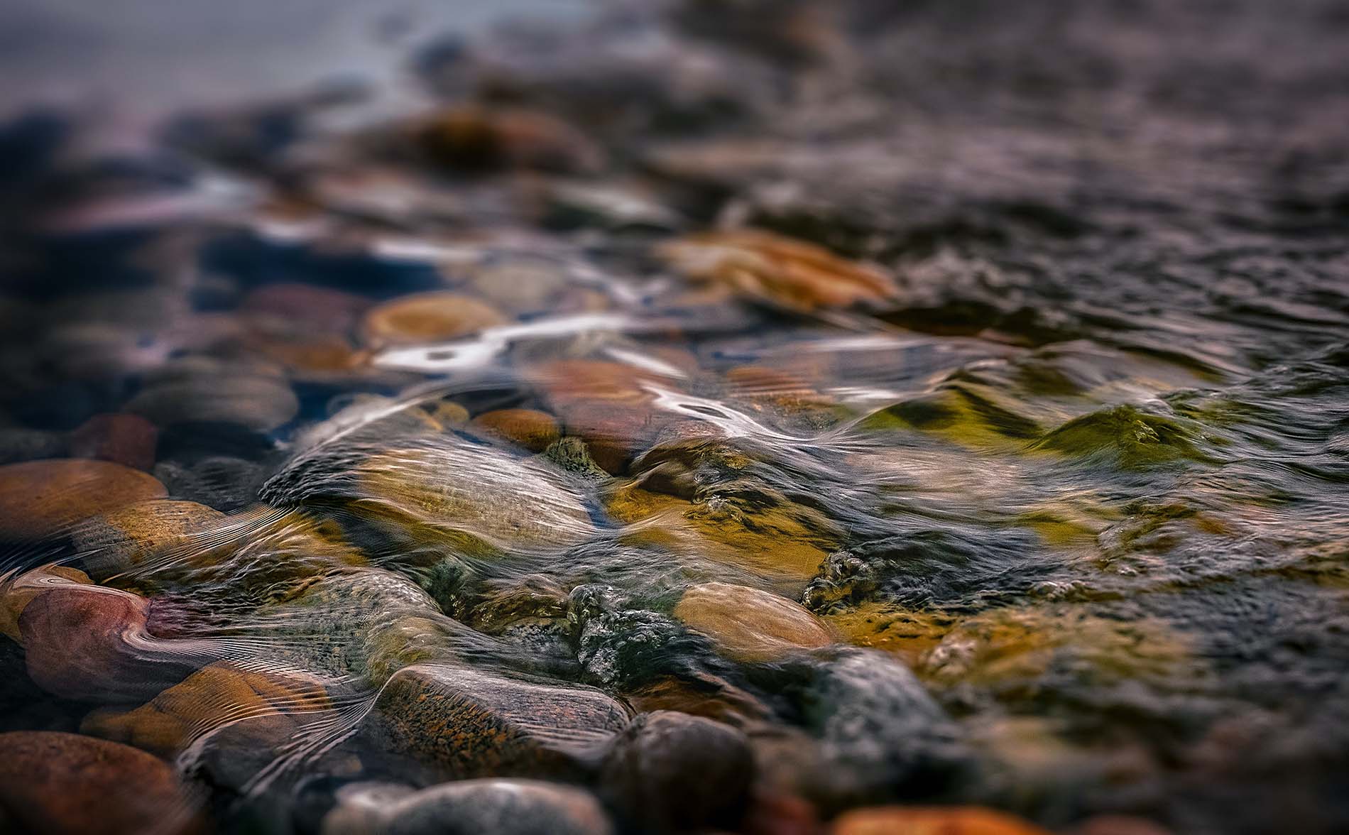 water running over river rocks