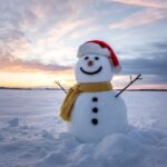 snowman with yellow scarf and red santa hat