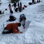 kids digging with shovels in the snow